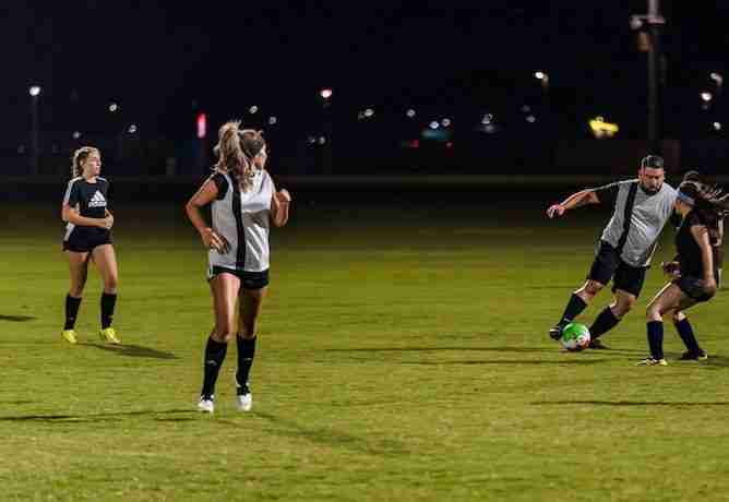 coed soccer with 2 women and man